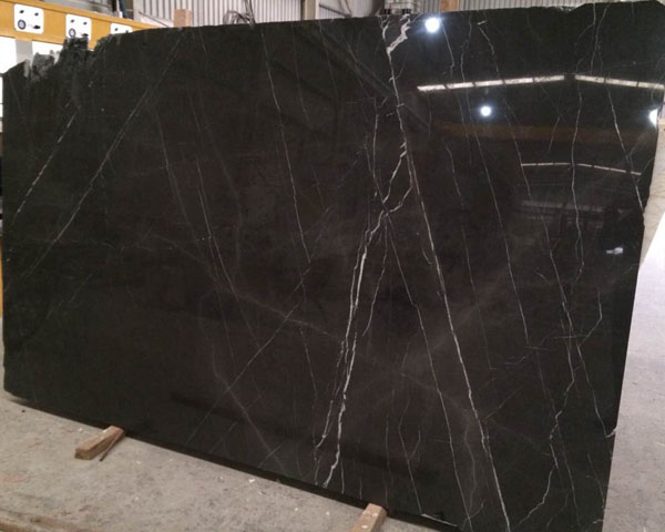 Polished dark colored black emperador marble slab